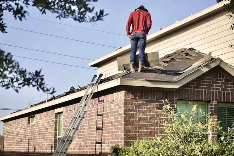 Professional roofer working on a residential roof in Roseville